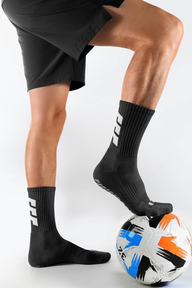 Black unisex soccer mid-calf socks with strong rubber grip sole and arch support