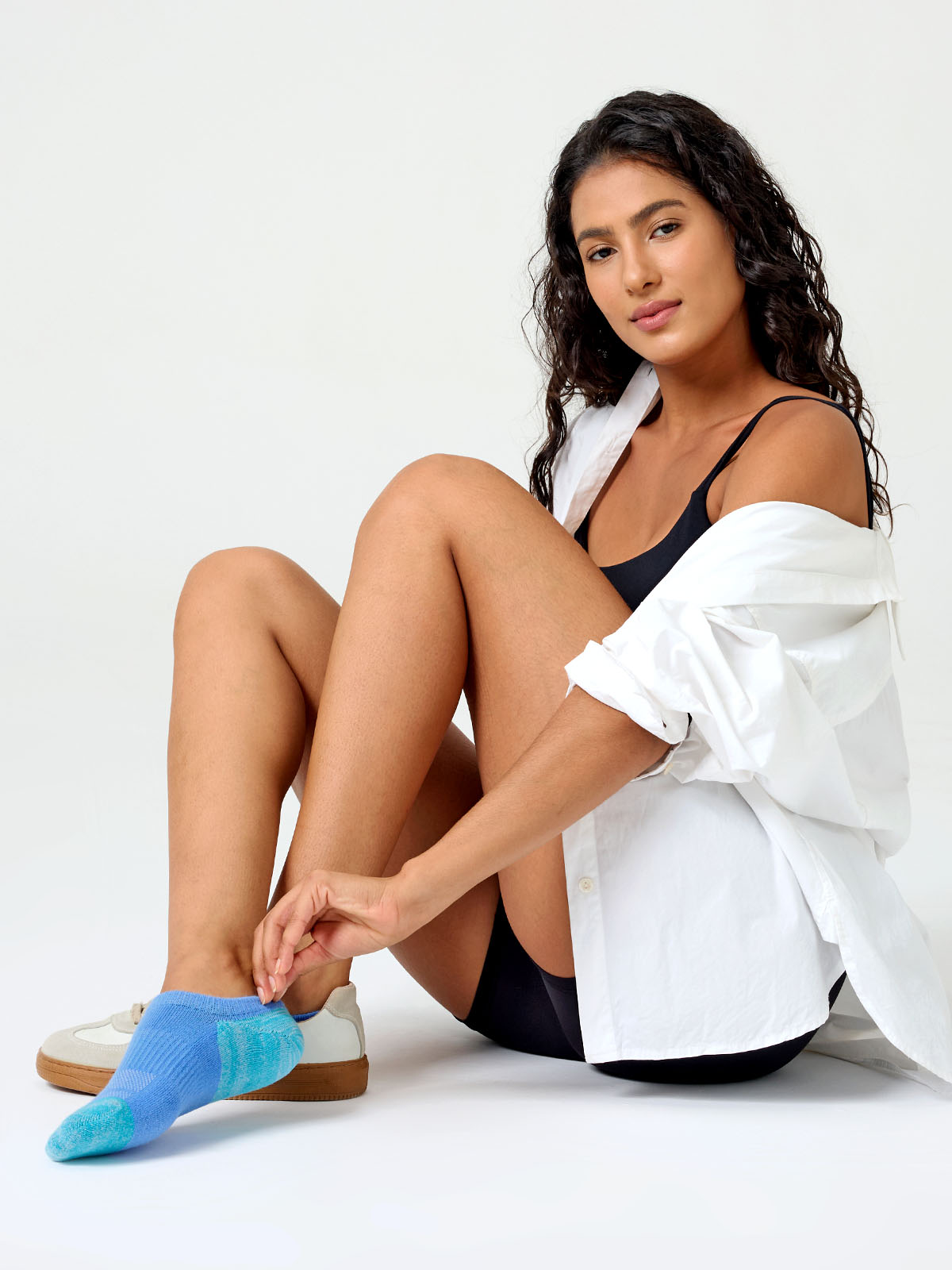 A detailed close-up product photograph of Closemate's light blue ribbed cotton no-show invisible boat socks, set against a smooth, neutral beige background. The image clearly highlights the breathable fabric texture, the precise contoured fit around the foot, and the intricate patterned weave on the footbed designed for comfort.