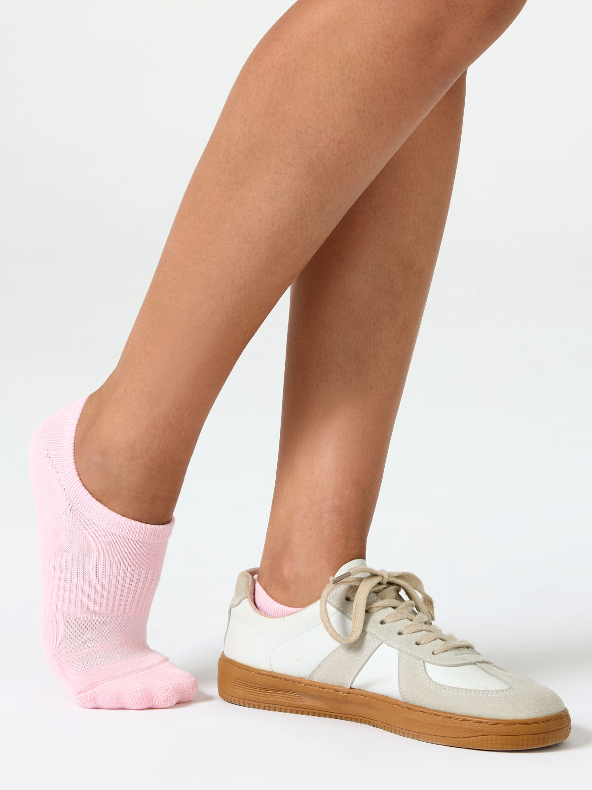 CW10_SWCH_PINK_PT01 A detailed close-up product photograph of Closemate's pink ribbed cotton no-show invisible boat socks, set against a smooth, neutral beige background. The image clearly highlights the breathable fabric texture, the precise contoured fit around the foot, and the intricate patterned weave on the footbed designed for comfort.